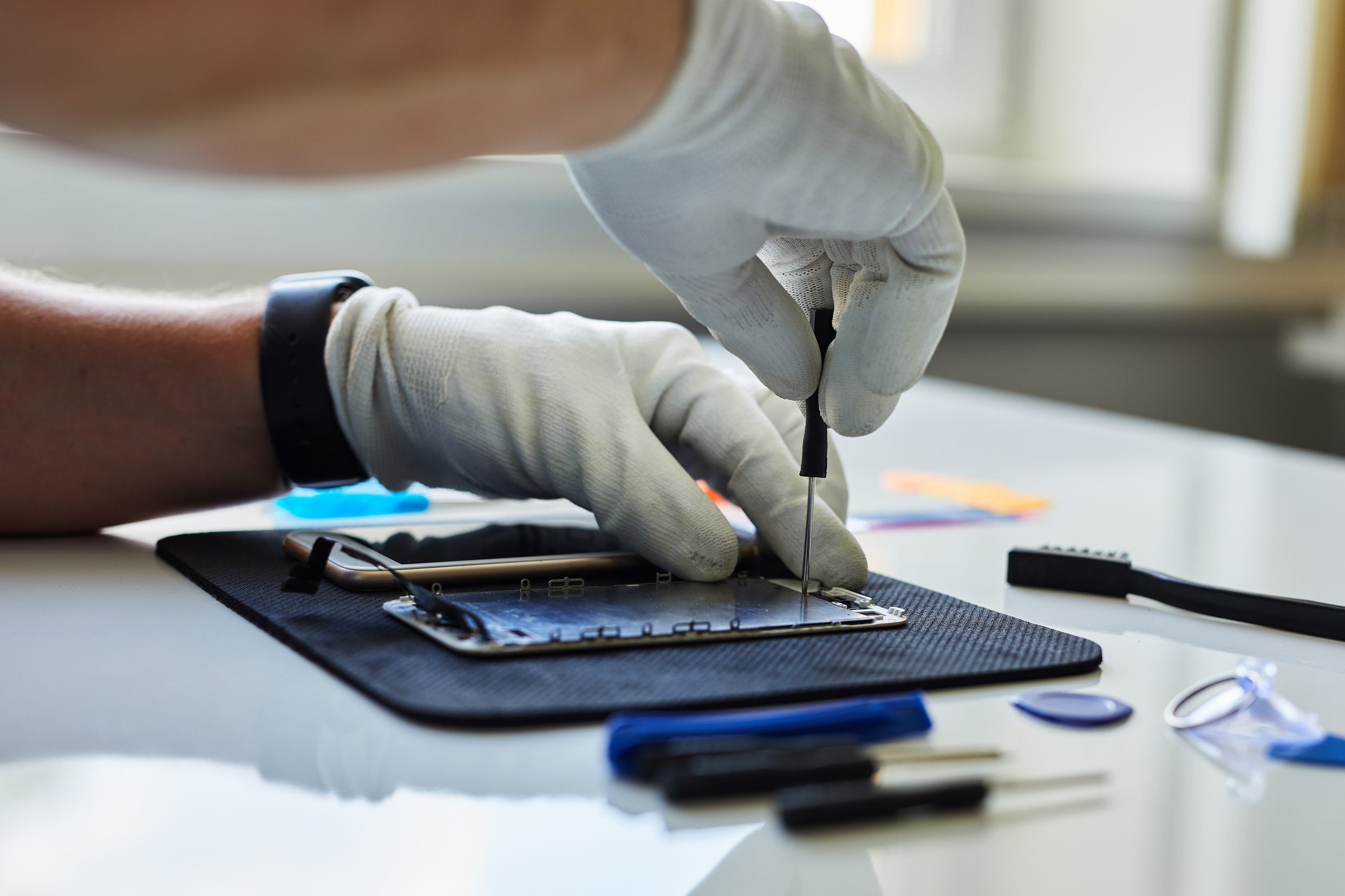 Phone Technician Fixing Smartphone